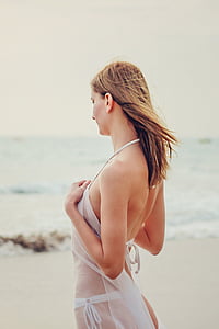 woman in white bikini in front of beach