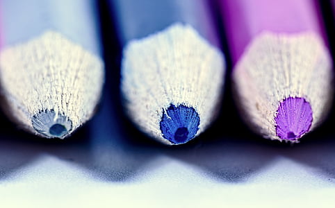 focus photography of gray, blue, and purple color pencils