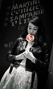 grayscale photography of woman holding candy