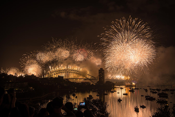 people watching bridge with fireworks
