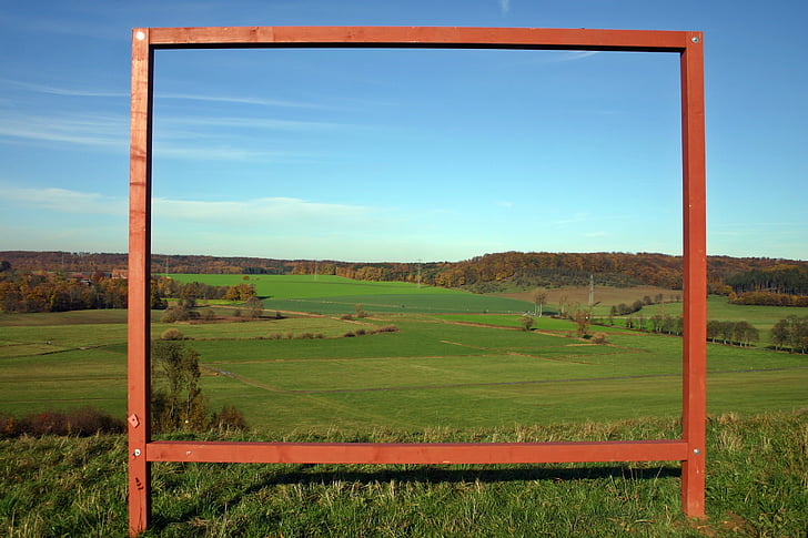 rectangular brown metal frame on green grass field