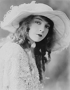 grayscale photography of woman in lace dress and hat