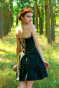 woman wearing green and black strapless dress
