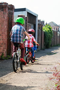 two children riding the bike