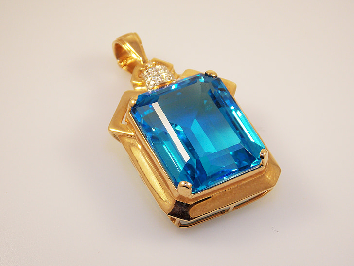 gold-colored blue gemstone stud pendant