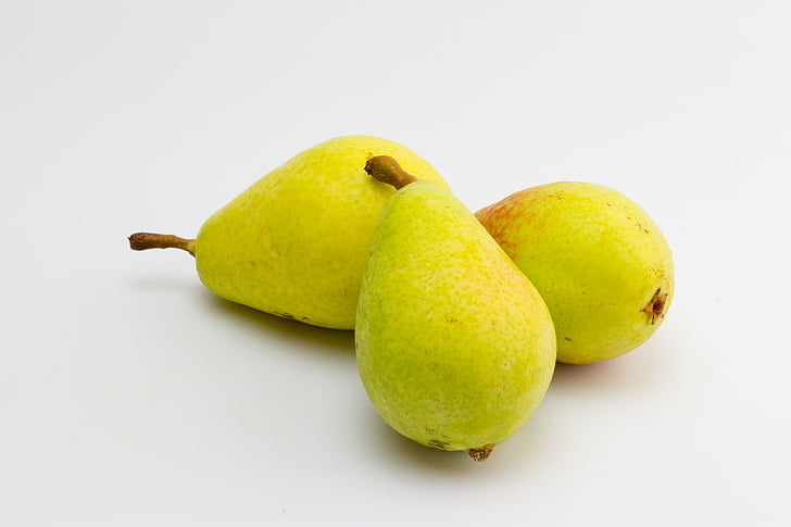 three yellow citrus fruits
