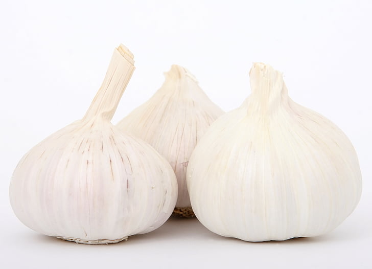 three white garlic bulbs