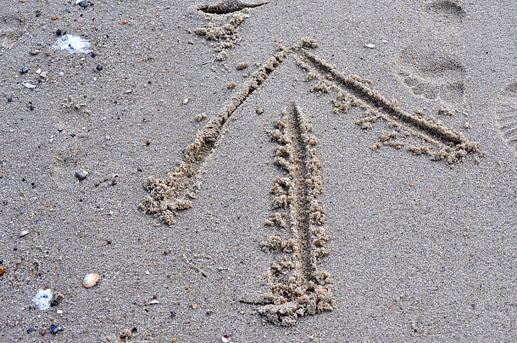 arrow drawn on sand