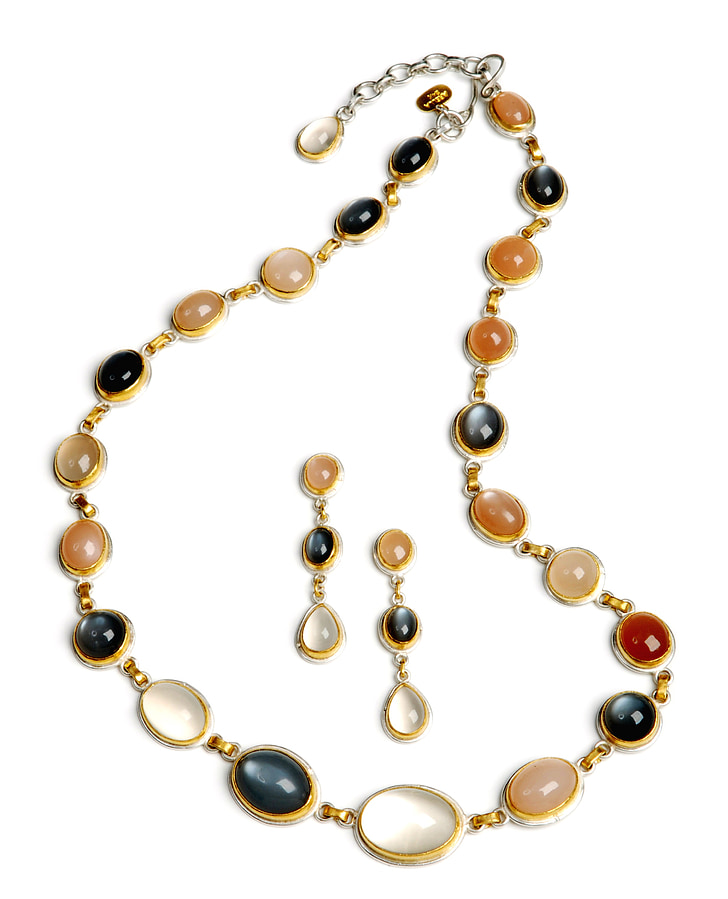 gold-colored necklace and earrings with gemstones