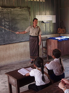 woman standing inside room beside chalkboard