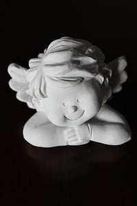 white ceramic cherub figurine