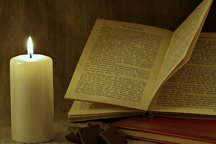 book and candle on table