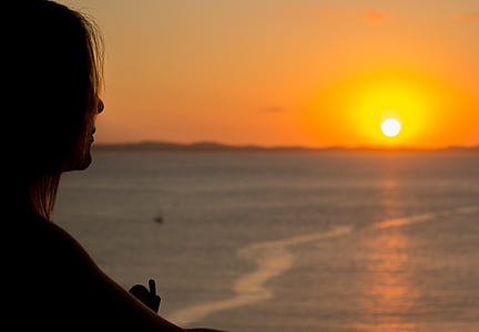 woman facing sunset