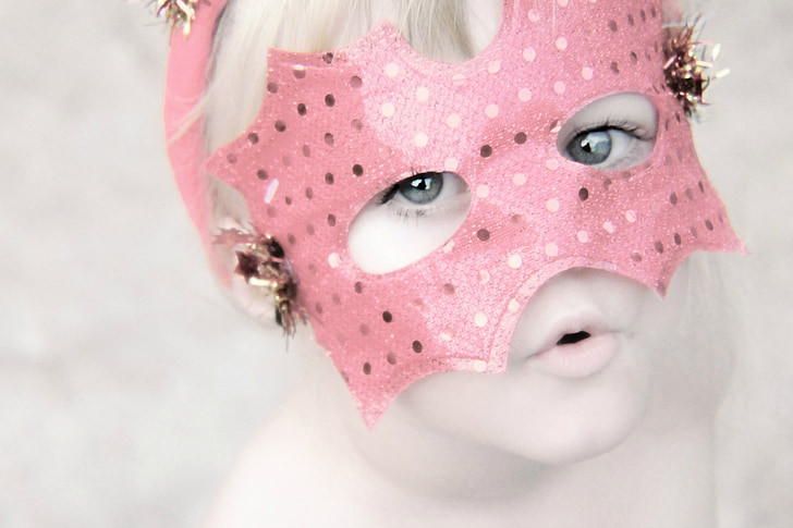 girl in pink masquerade mask