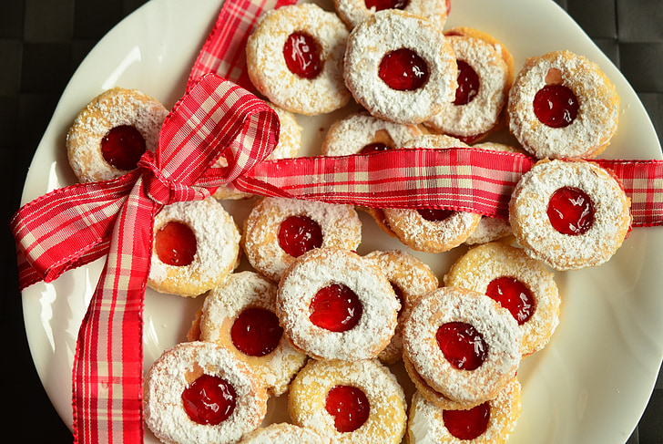 high angle photo of plate of doughnuts with red strawberry jam