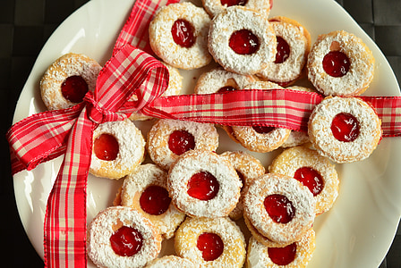 high angle photo of plate of doughnuts with red strawberry jam