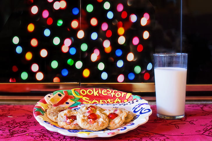 cookies on plate beside glass filled with milk