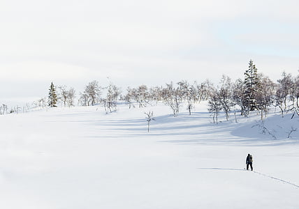 man walking along snow-covered surface