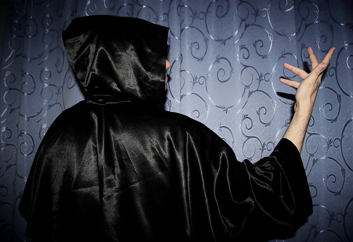 person wearing black hooded dress