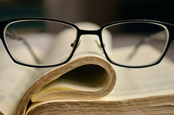black frame eyeglasses on book page