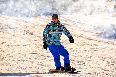 photo of man in snowboard during daytime