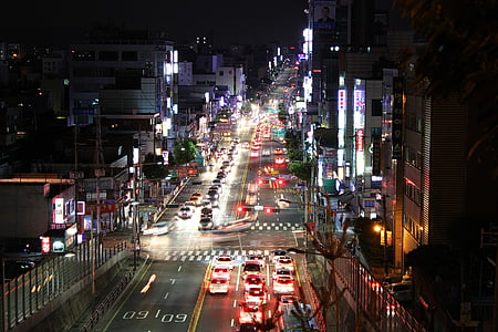 aerial photography of city intersection with buildings and heavy traffic at night
