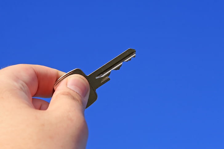 person holding key
