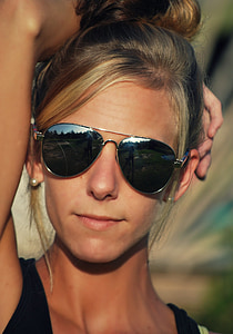 photo of woman wearing gray framed aviator-style sunglasses
