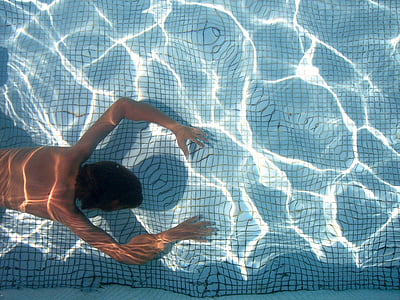 person swimming under the water