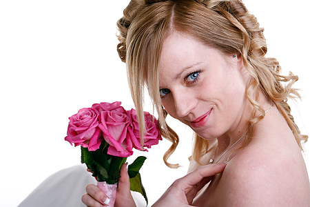 woman holding pink rose bouquet