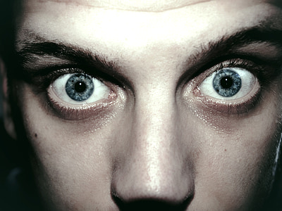 close-up photo of person's pair of blue eyes