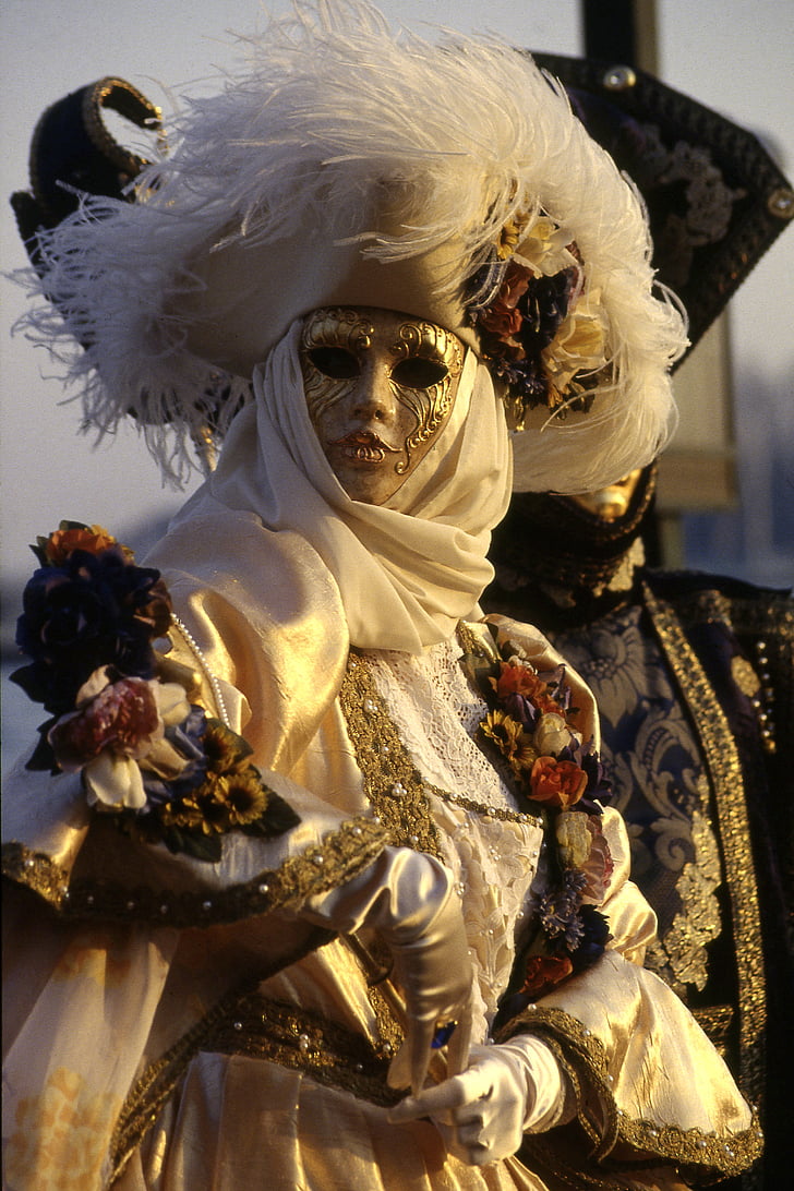 woman wearing masquerade mask and gown