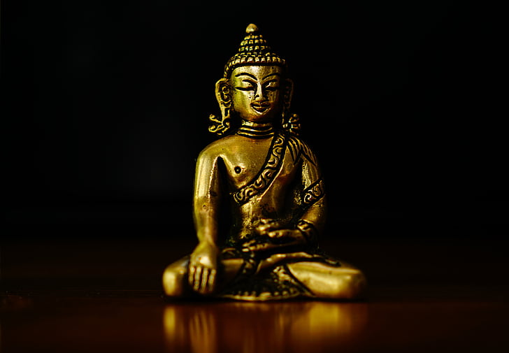 Bhumisparsha Mudra figurine on brown surface