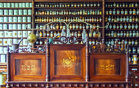 brown wooden sideboard with assorted bottles