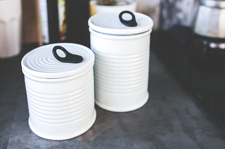 two white ceramic canisters in macro photography