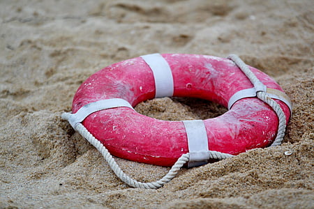 red lifeguard ring on sand