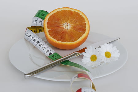 slice orange fruit on white ceramic plate