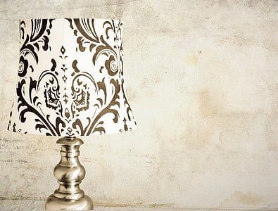 brown and white floral table lamp on beige surface