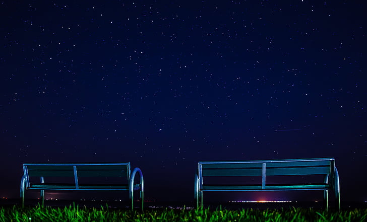 two silver metal bench on green grass field