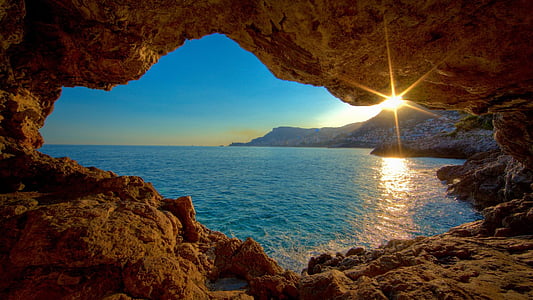 landscape photography of seaside in cavern during daytime
