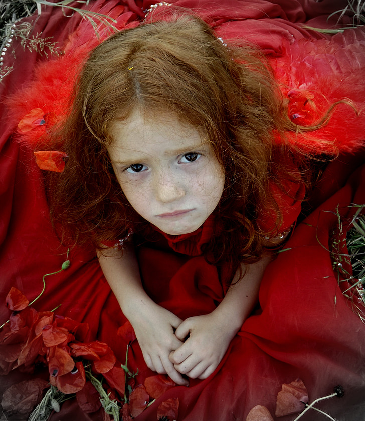 girl wearing red dress while sitting