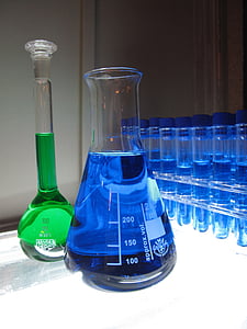 two green and blue liquid filled clear glass containers