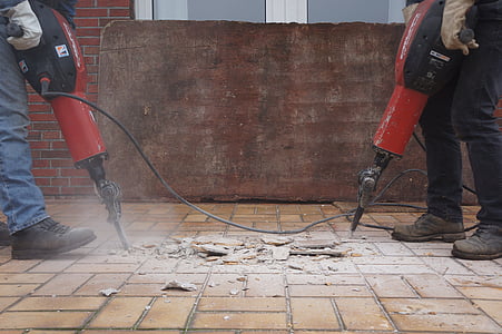 two people drilling floor