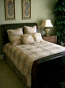 arrange bed sheet set beside brown wooden nightstand
