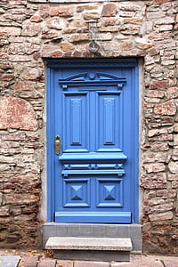 blue wooden door closed during daytime