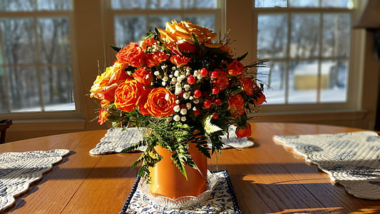 orange petaled flowers on vase arrangement