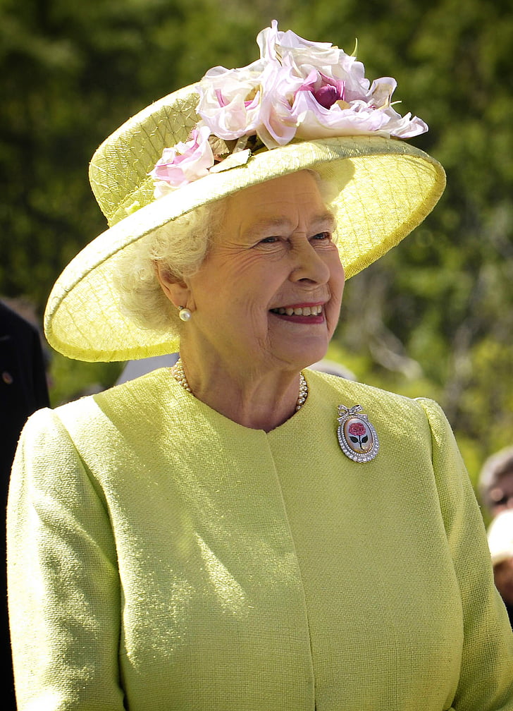 Queen Elizabeth II wearing yellow sun hat