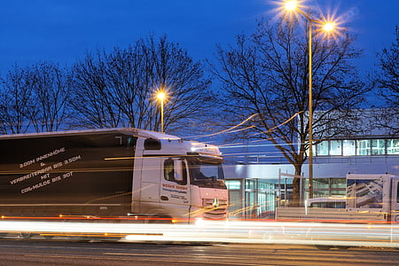 timelapse photograph of white Mercedes-Benz Axor single cab box truck running on road