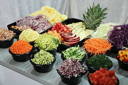 chops of vegetables and fruits in bowls and trays