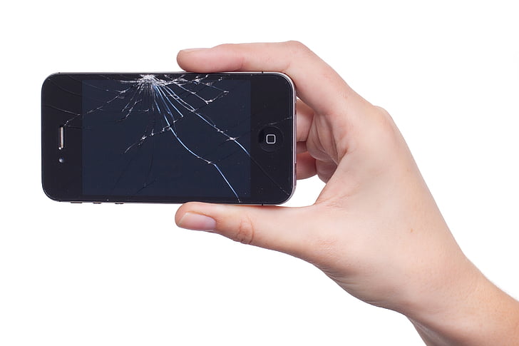 person holding cracked iPhone 4